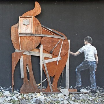 A sculpture of an elephant from scrap wood parts